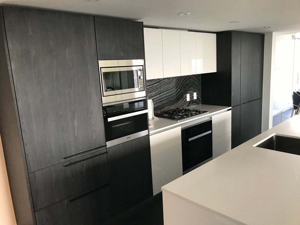 a black and white kitchen with a stove and a microwave