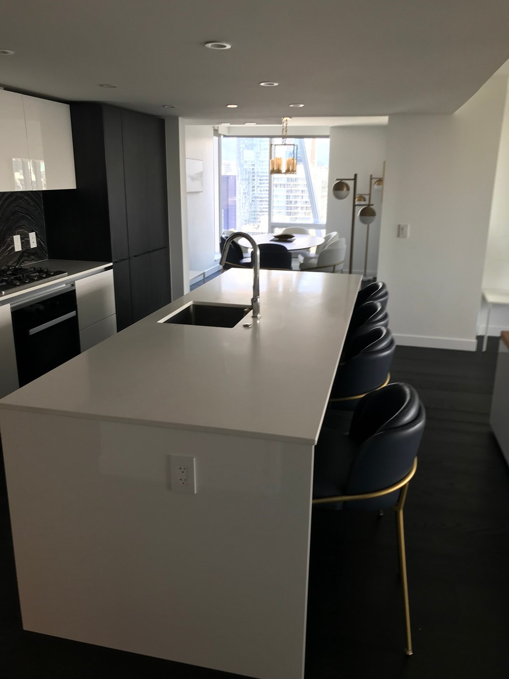 a kitchen with a white counter top and a sink