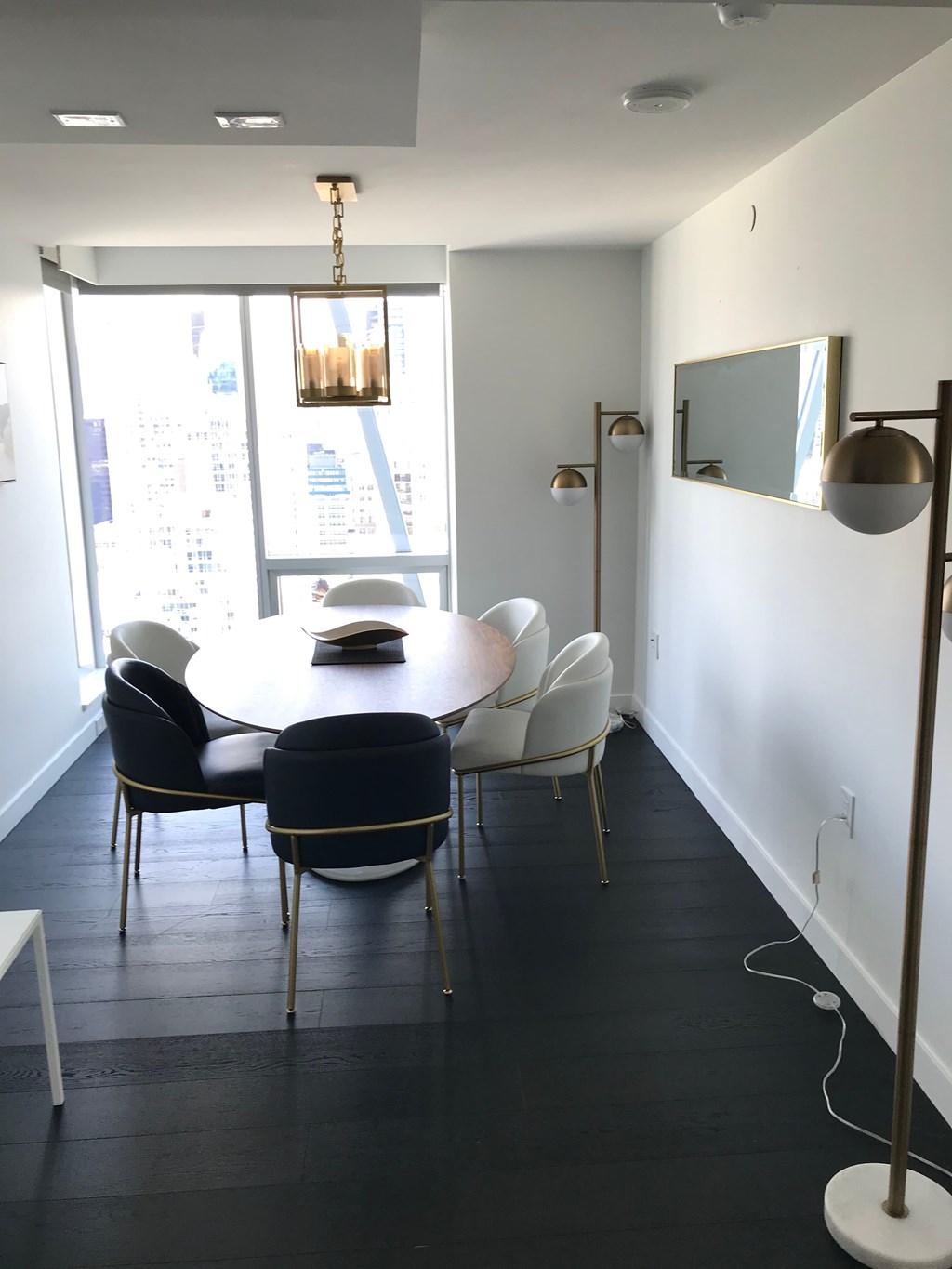 a dining room with a table and chairs and a window