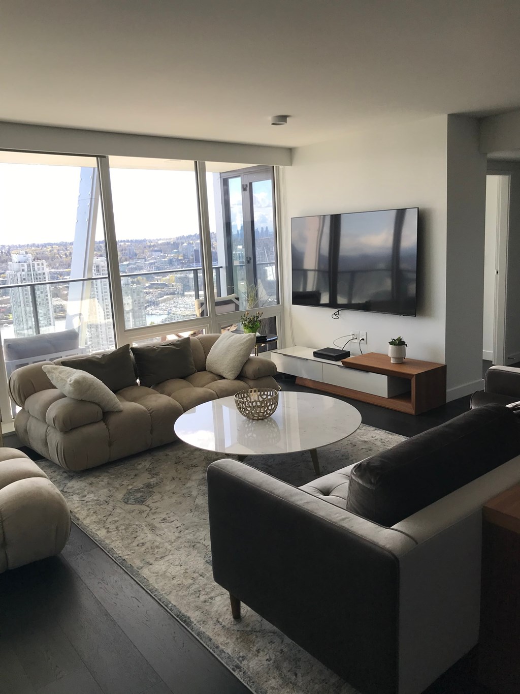 a living room with couches and a table and a television