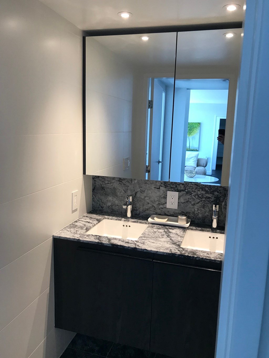 a bathroom with two sinks and a large mirror