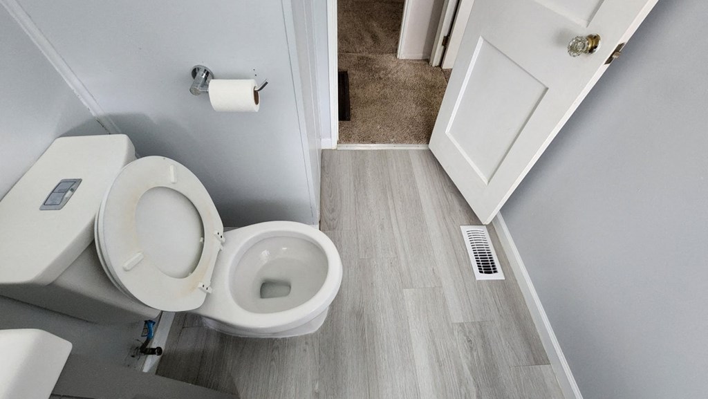 a small bathroom with a toilet and a door