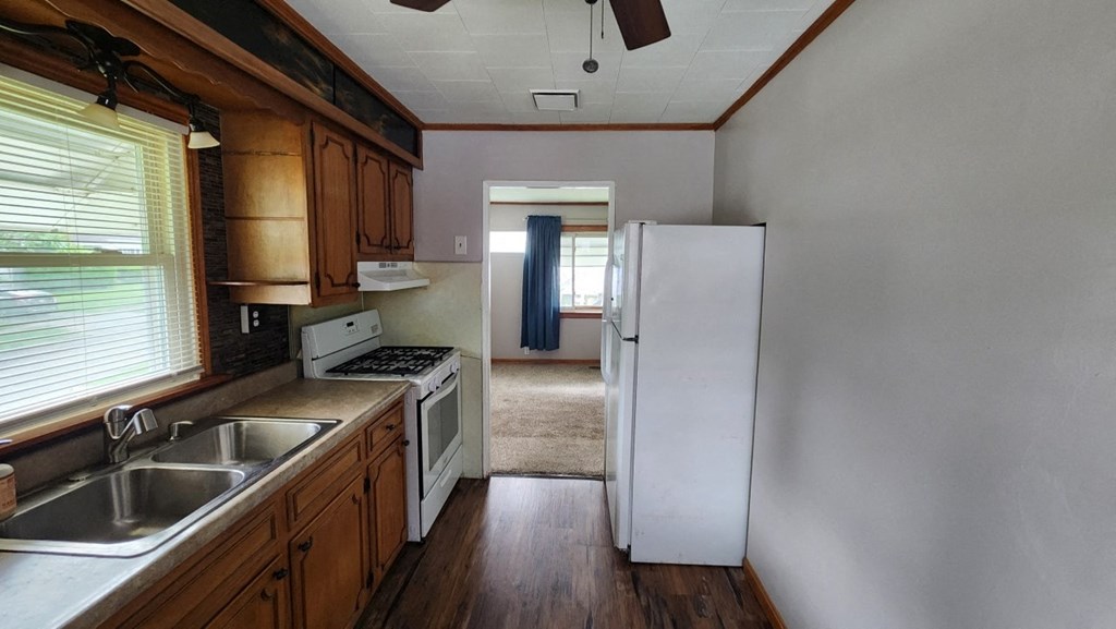 a kitchen with a sink and a refrigerator