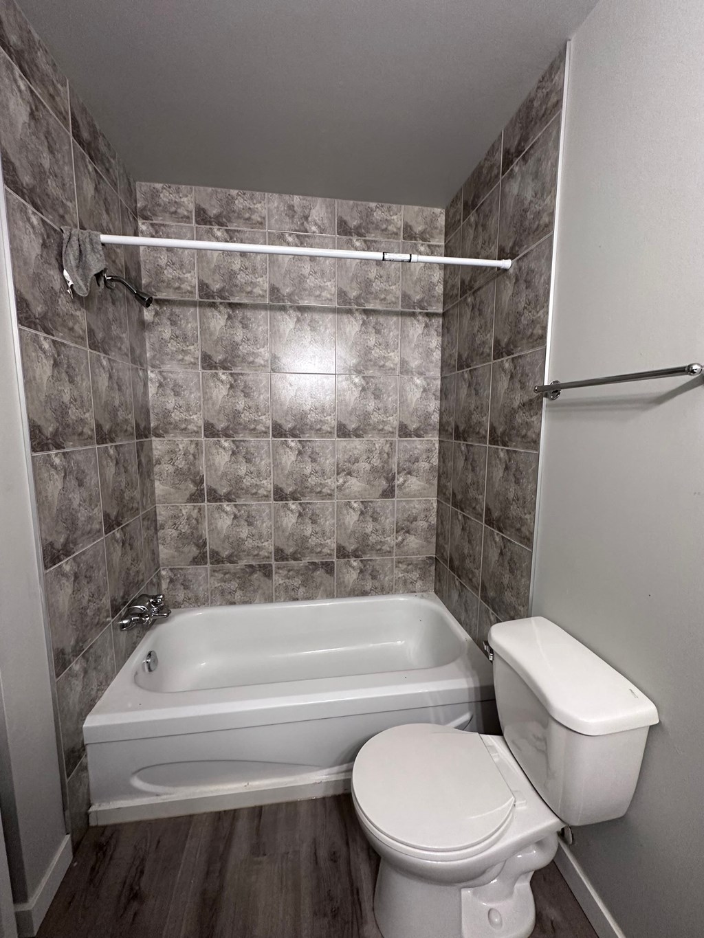 a small bathroom with a toilet and a bath tub
