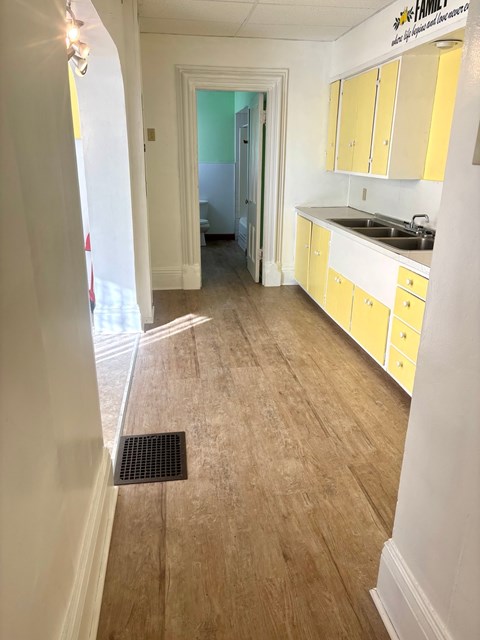 A kitchen with yellow cabinets and a sink.