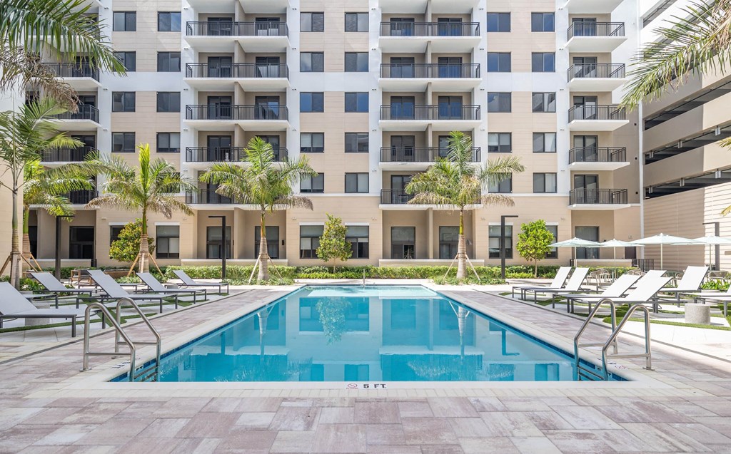 a swimming pool in front of an apartment building