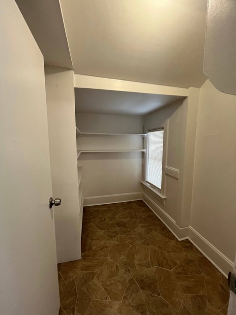 a bedroom with a closet and a window