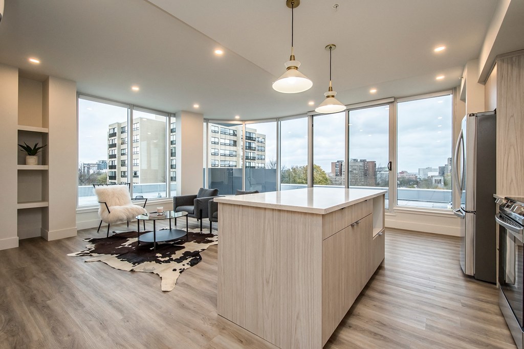 an open kitchen and living room with a view of the city