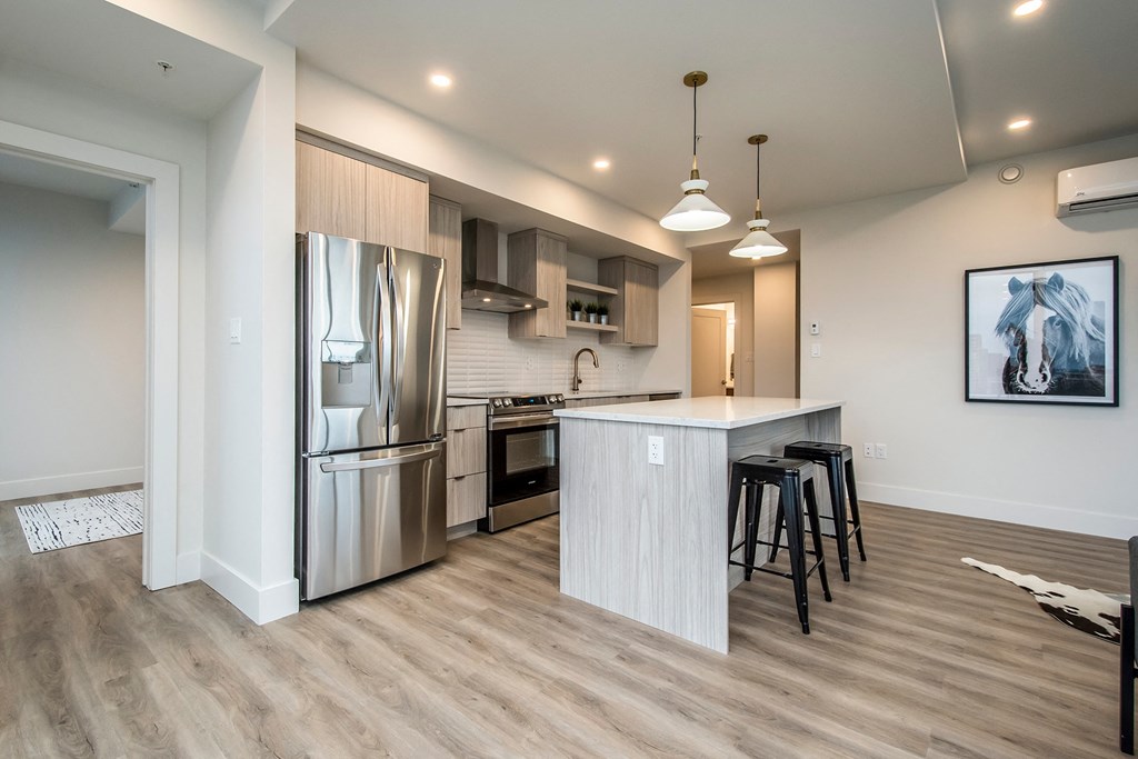 a kitchen with stainless steel appliances and an island with stools