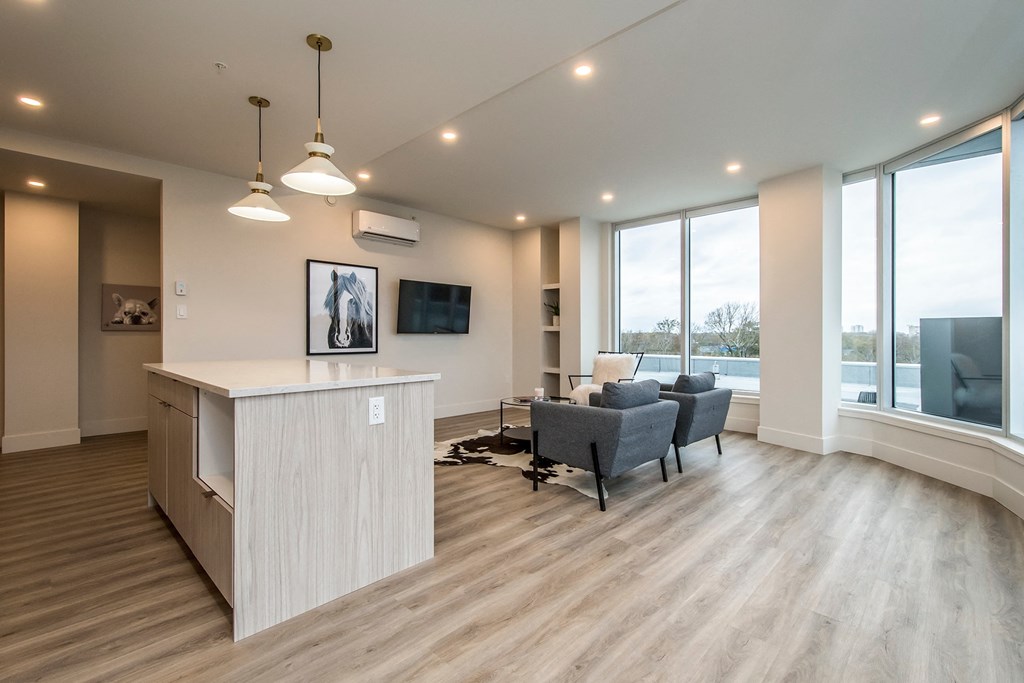 a living room with a kitchen and a couch and a table