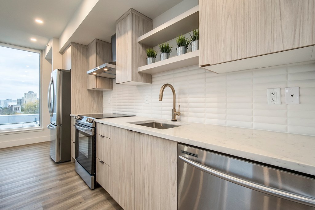 a kitchen with wooden cabinets and stainless steel appliances