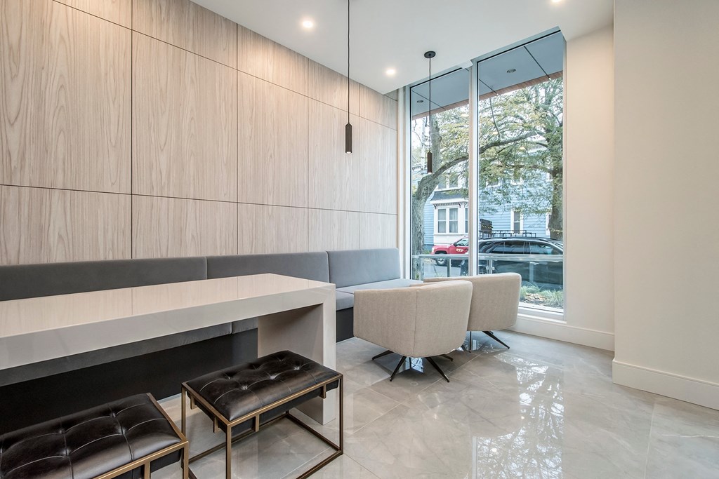a living room with a table and chairs and a large window