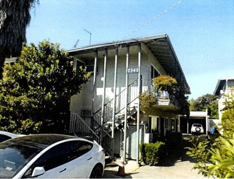 an old building with a car parked in front of it