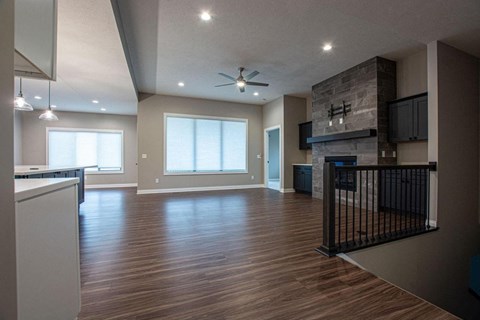 a living room with a fireplace and a wooden floor