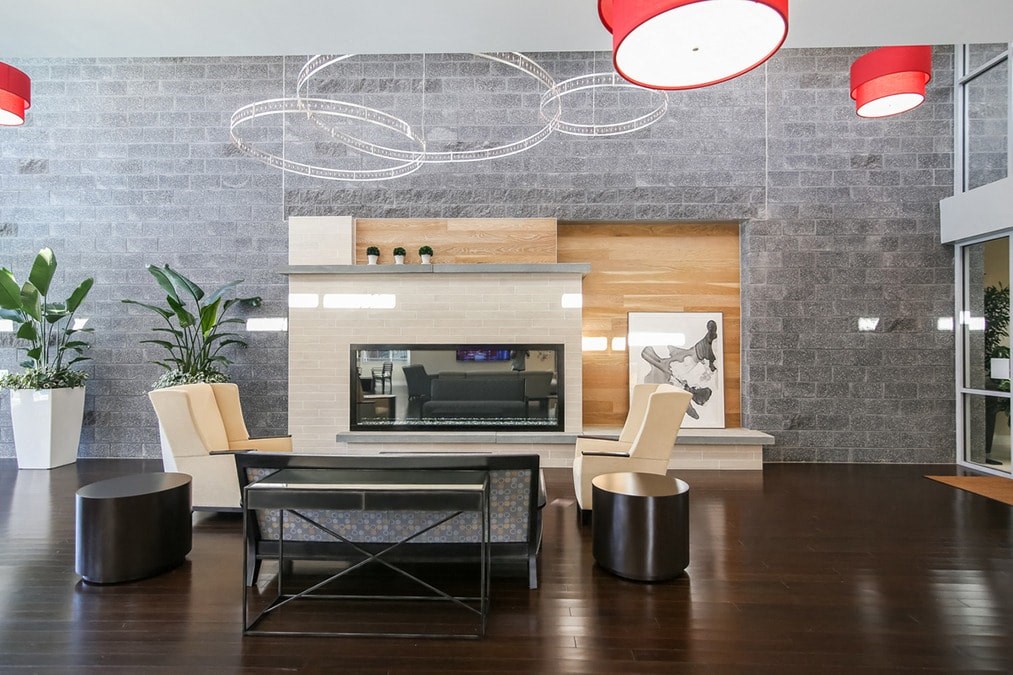 a living room with a fireplace and a table and chairs