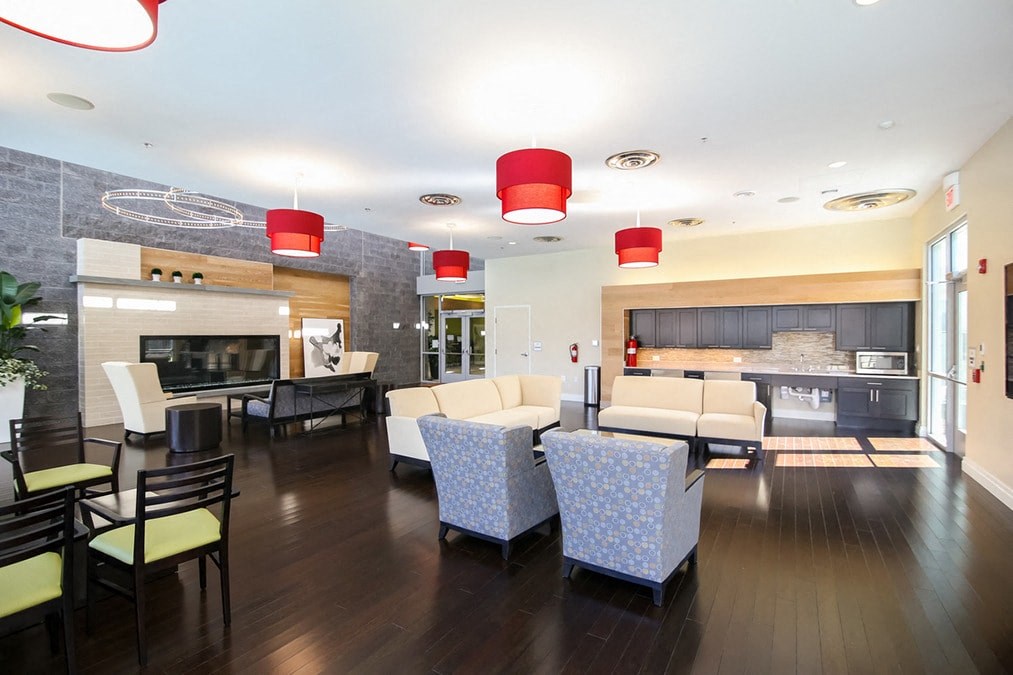 a large living room with couches and chairs and a fireplace