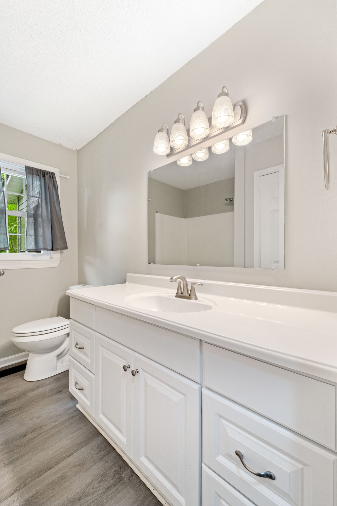 a white bathroom with a sink and a toilet