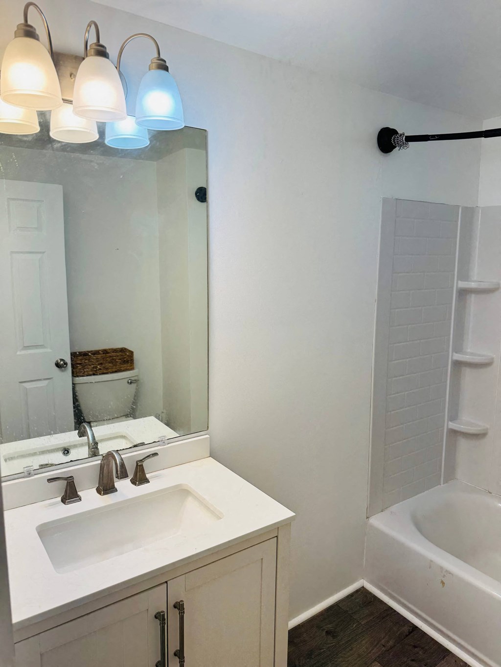 a bathroom with a sink and a mirror and a tub
