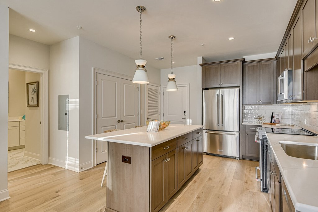 A modern kitchen with wooden cabinets and stainless steel appliances.