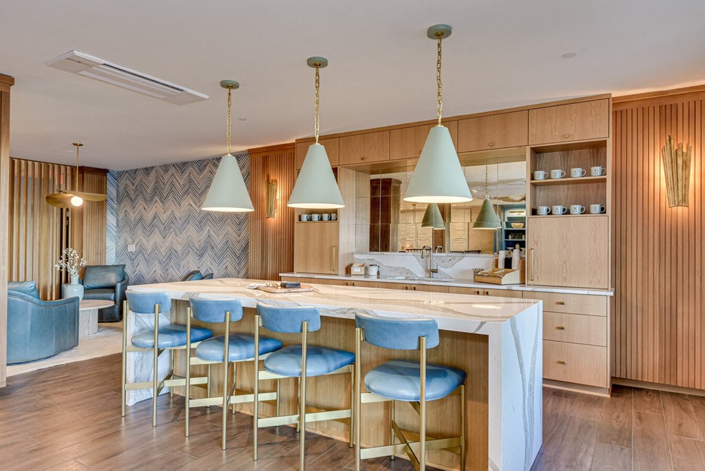 A kitchen with a dining table and chairs.