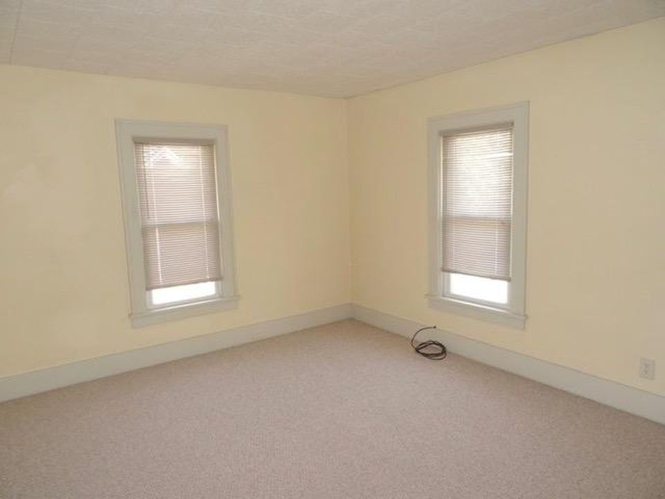 A room with two windows and a white ceiling.