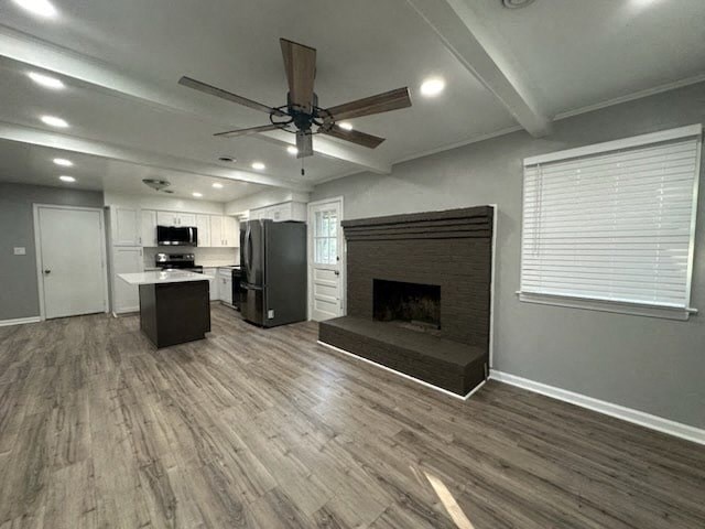 a living room with a fireplace and a kitchen