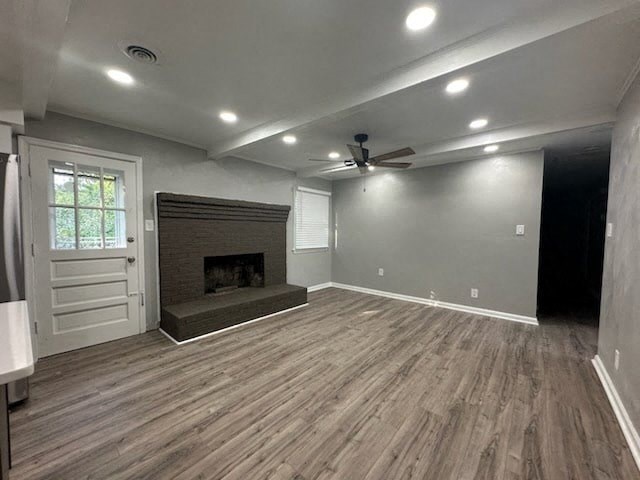 a empty living room with a fireplace and a ceiling fan