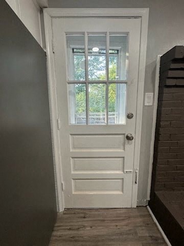 a white door with a window in a hallway