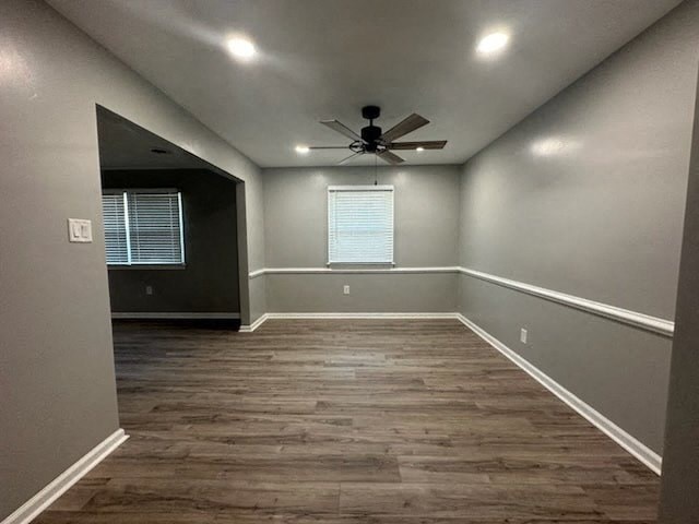 a empty room with a ceiling fan and a window