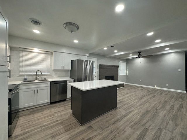 an empty kitchen with a refrigerator and a sink