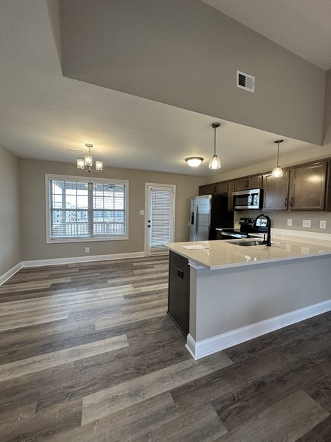 an open kitchen and living room with a counter top