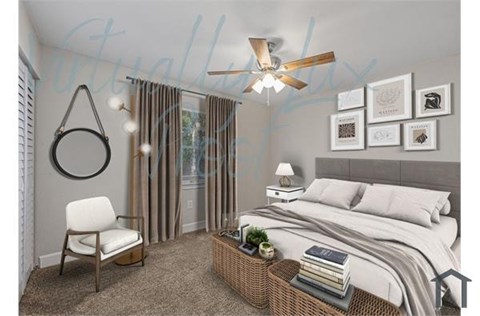 A bedroom with a bed, chair, and a ceiling fan.