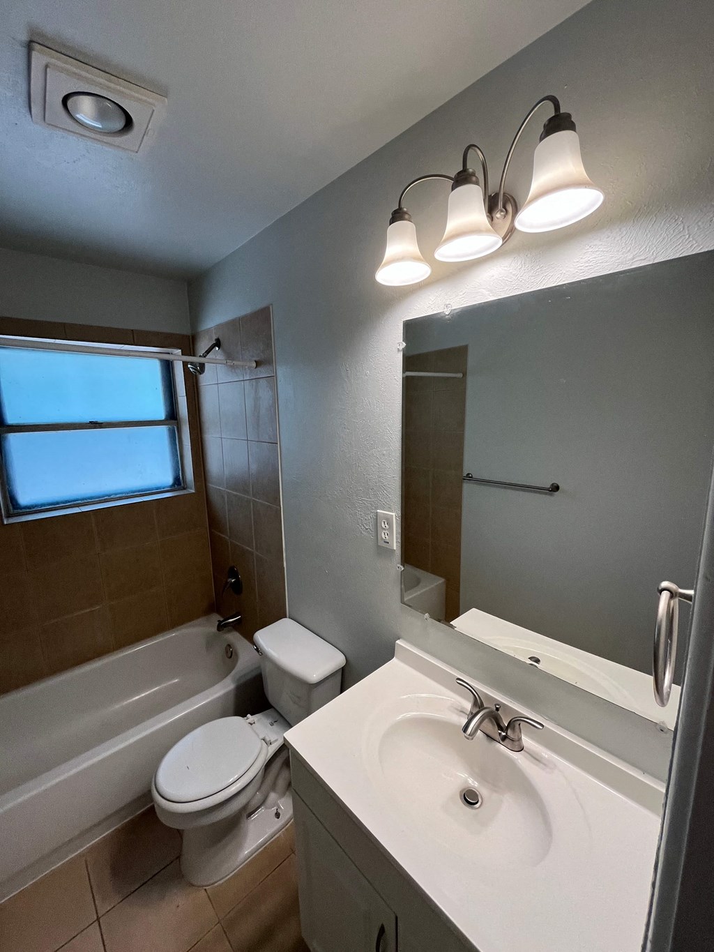 a bathroom with a sink and a toilet and a bath tub