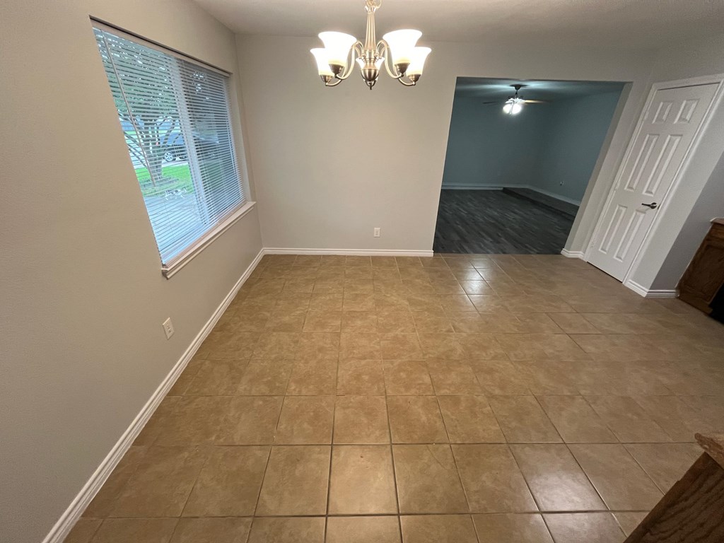 A room with a tiled floor and a chandelier.