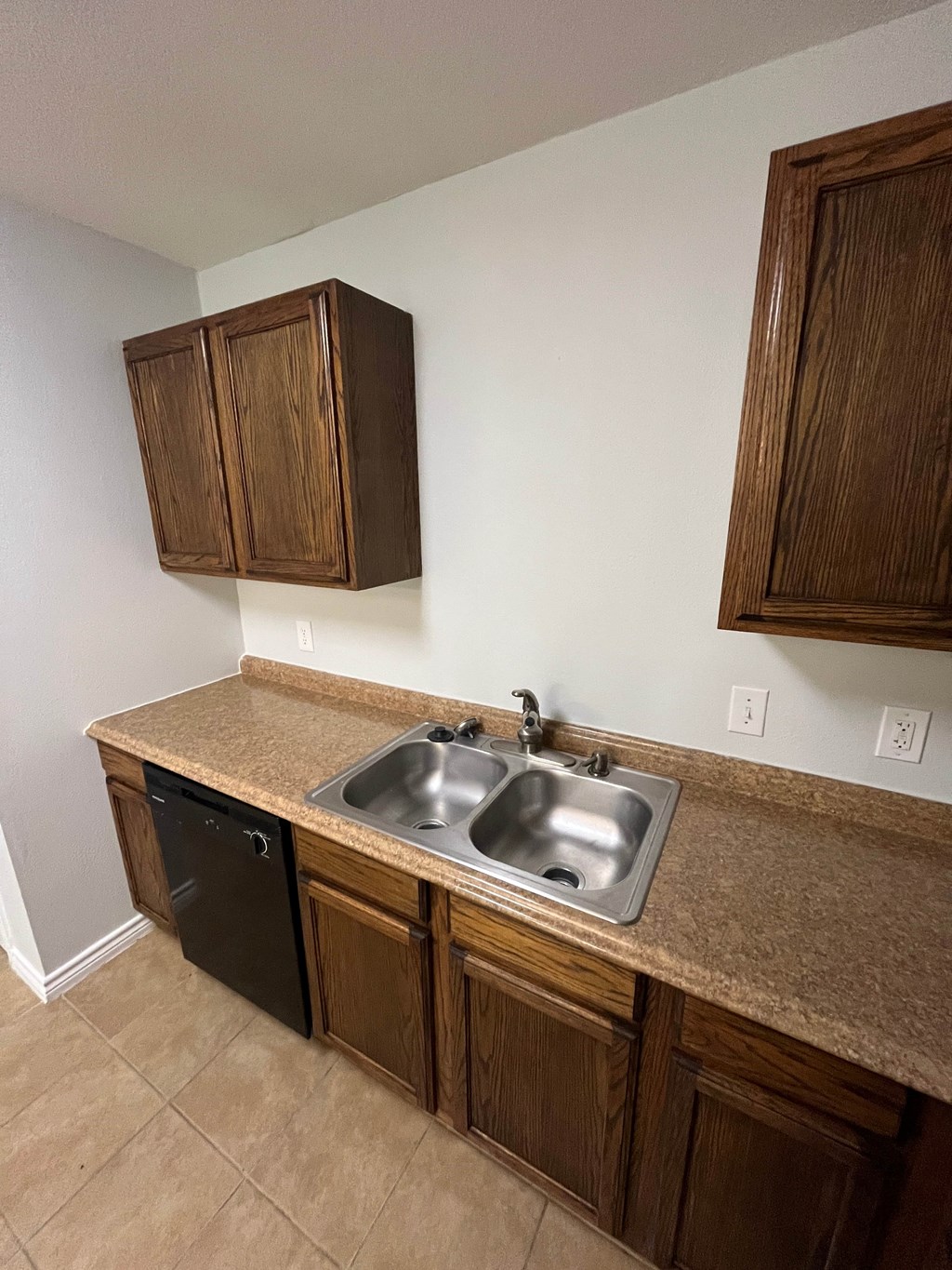 A kitchen with a sink and a dishwasher.