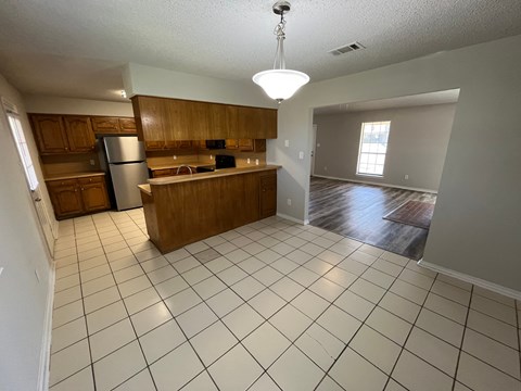 an open floor plan with a kitchen and a living room