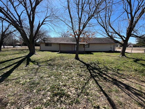a house in a field with trees