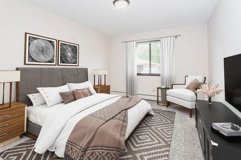 a bedroom with a bed and a tv