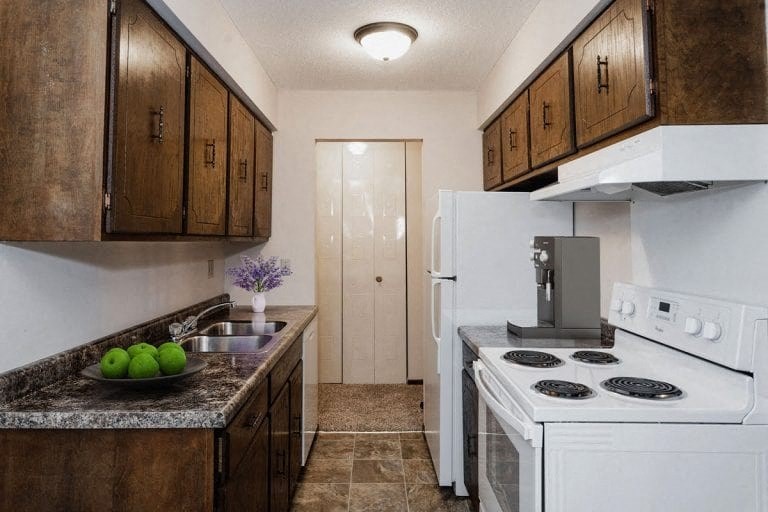 a kitchen with a stove refrigerator and a sink