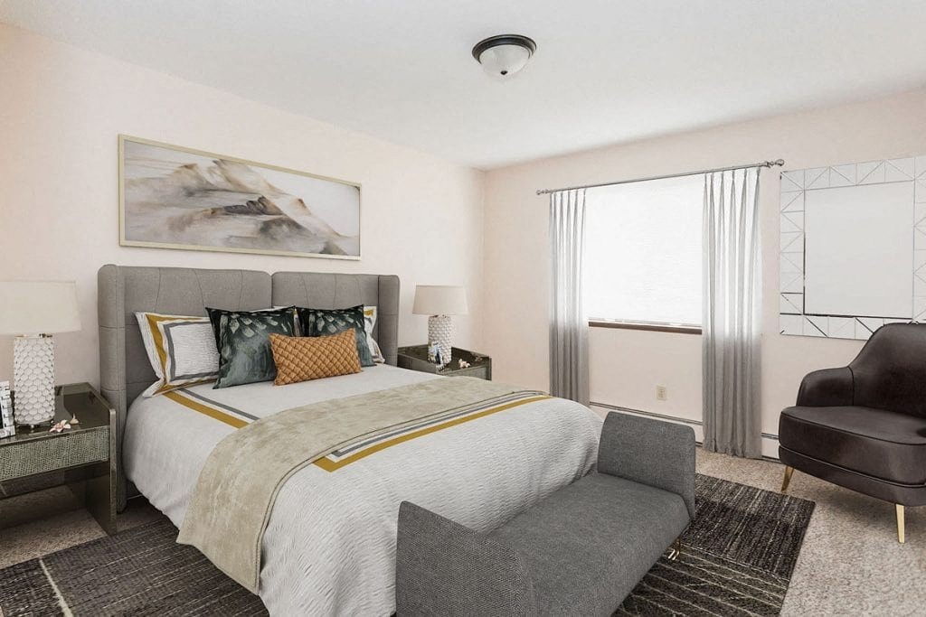 a bedroom with a bed and a chair and a window