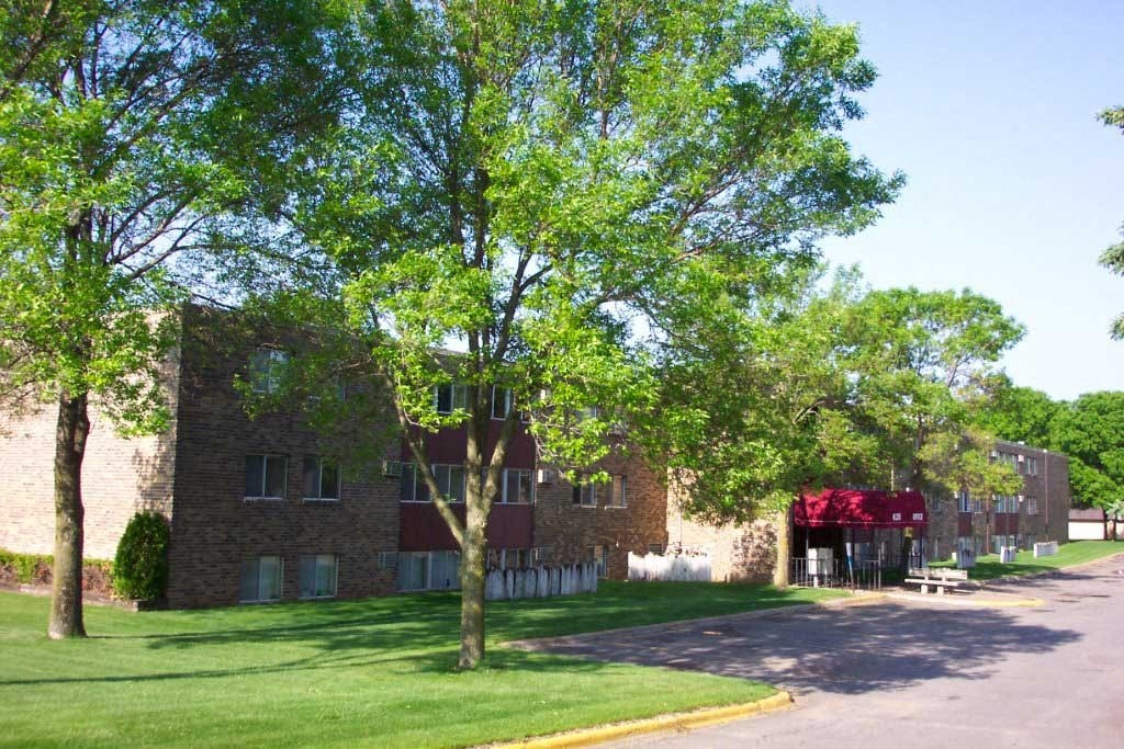 a large brick building with trees in front of it