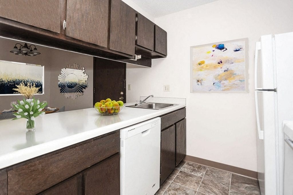 a kitchen with a sink and a refrigerator