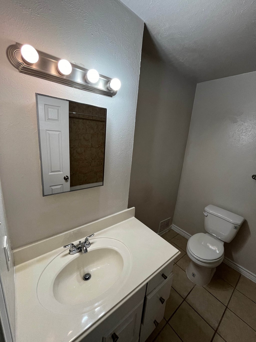 a bathroom with a sink and a toilet and a mirror