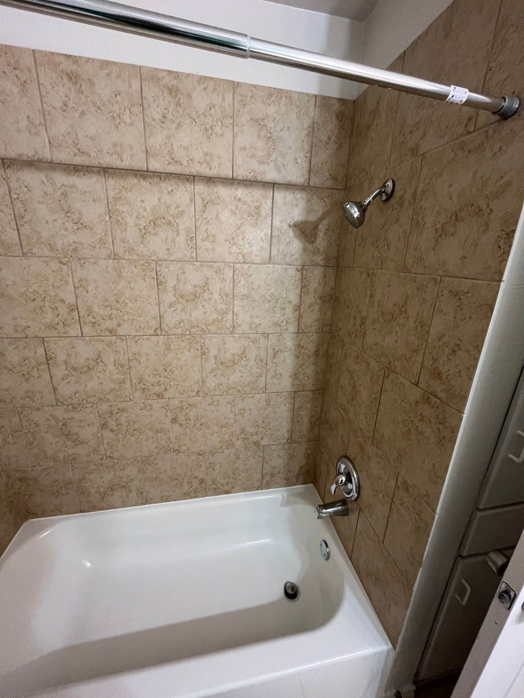 a bathroom with a white tub and a shower curtain