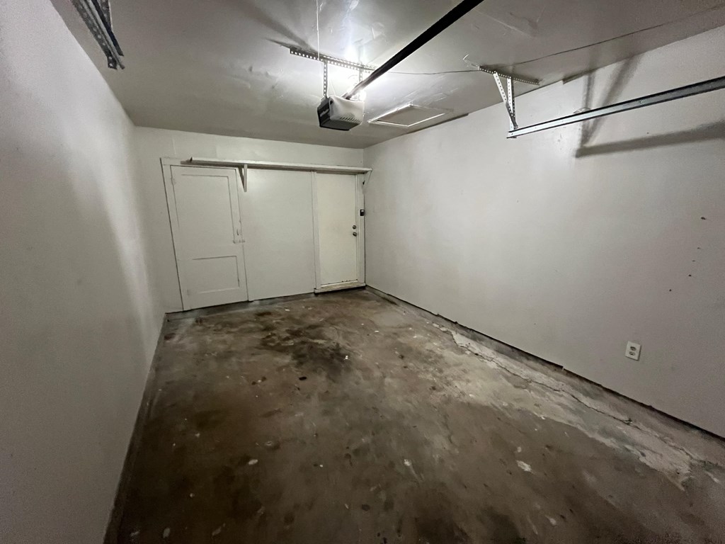 an empty room with white walls and a dirty floor