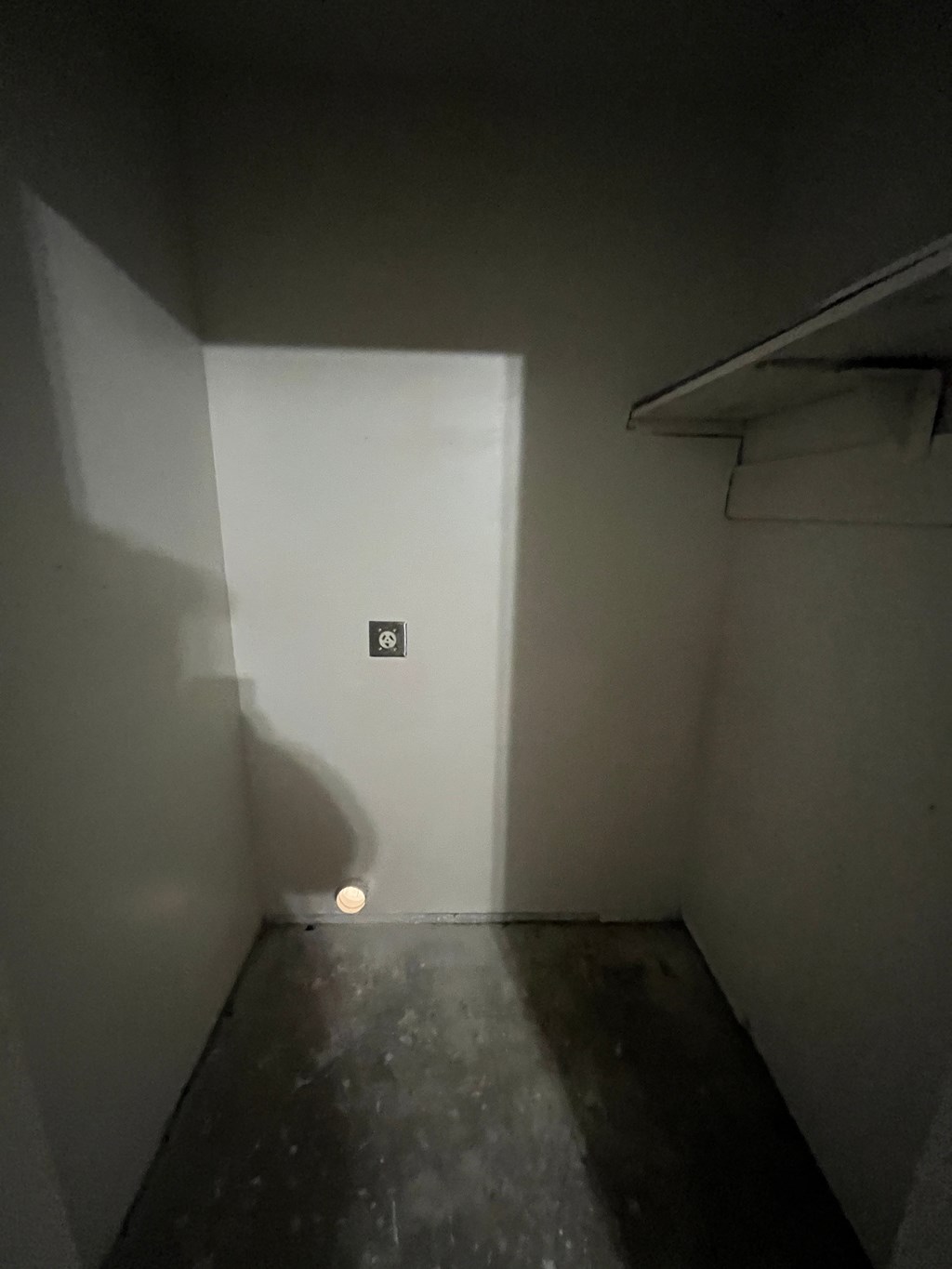 a room with a hole in the wall and a light on the floor