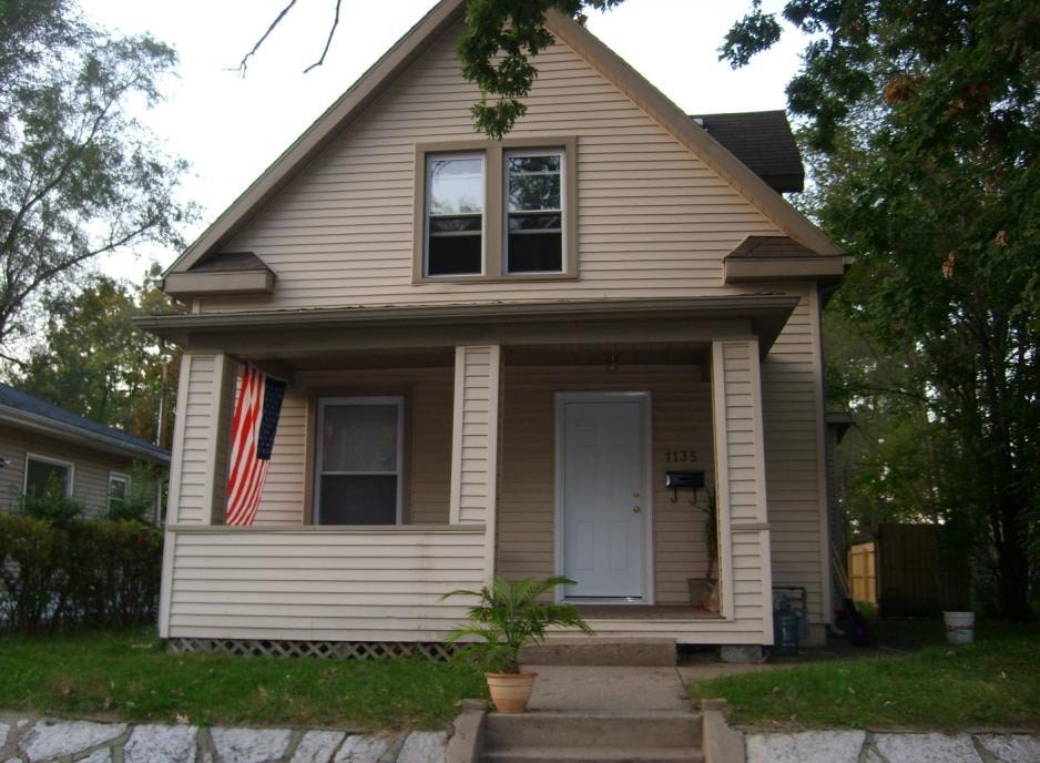 A house with a flag on the window.