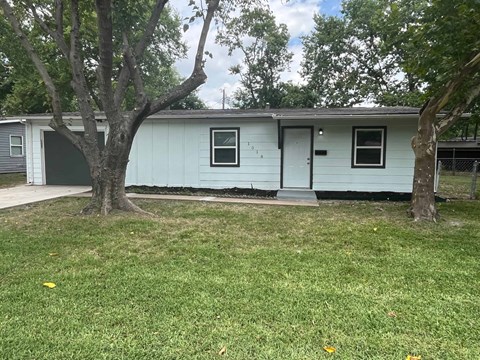 a white house with trees in front of it