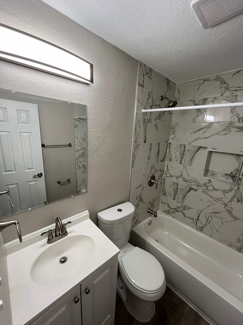 a bathroom with a sink toilet and a tub