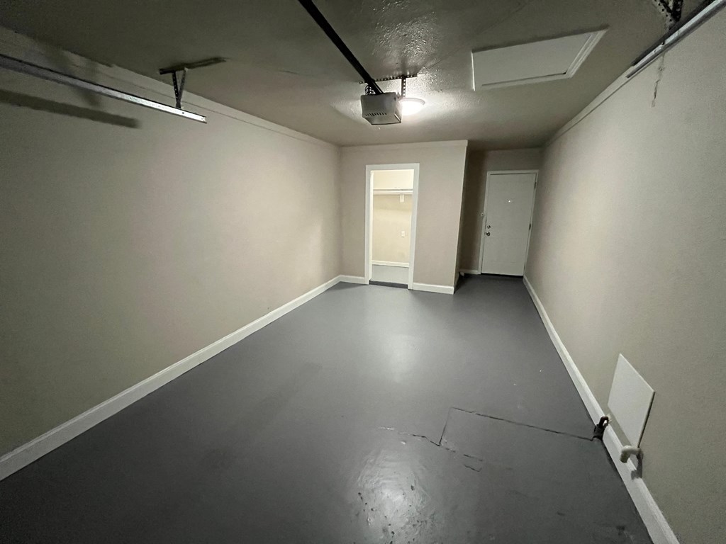 a empty room with white walls and a gray floor
